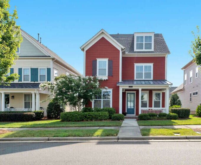 Red two-storey house with white trim