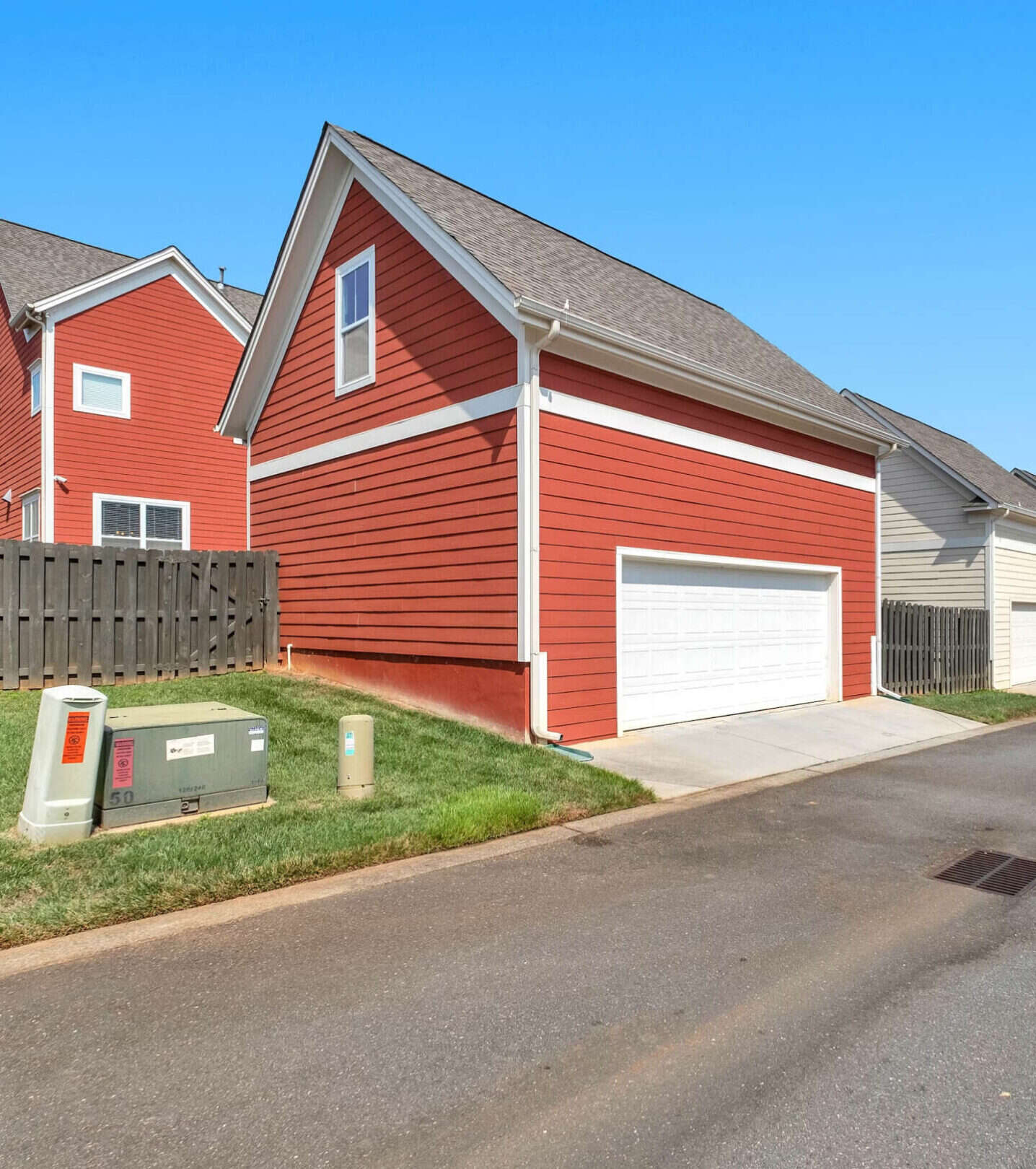 Red clapboard houses under a blue sky