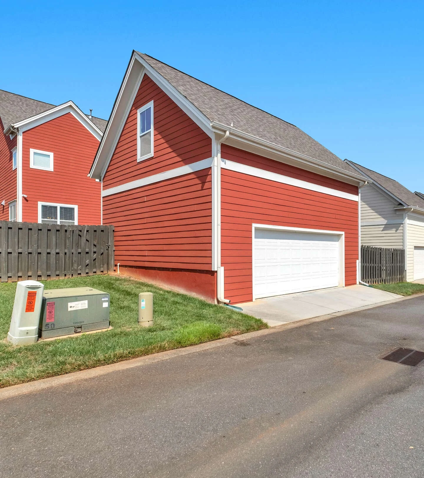 Red clapboard houses under a blue sky