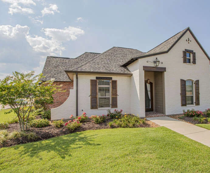 White stucco house with a front lawn