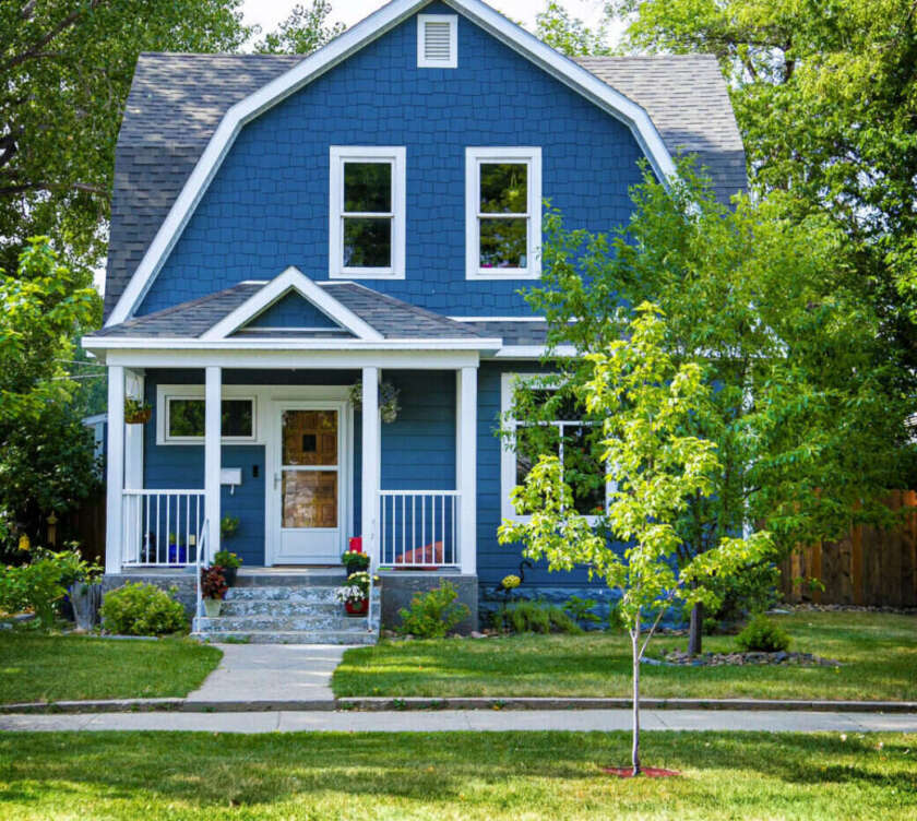 Blue two-storey house with a white porch